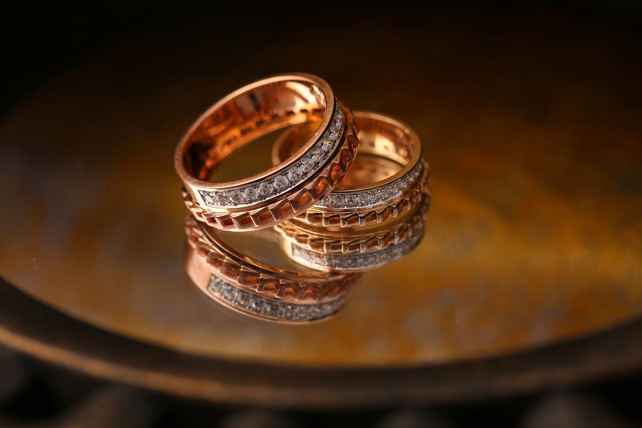Services Close-up of luxury gold and diamond wedding rings reflecting light beautifully.